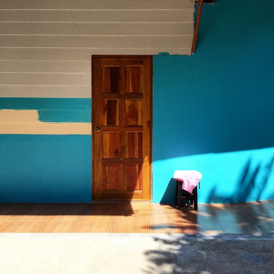 A shelf against a deep blue painted wall.