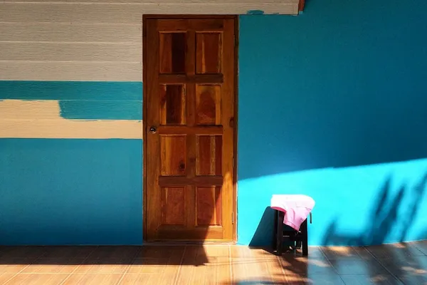 A shelf against a deep blue painted wall.