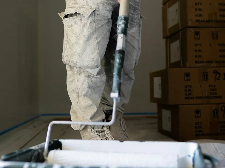 A painter rolling a fresh coat of colour onto an interior wall.
